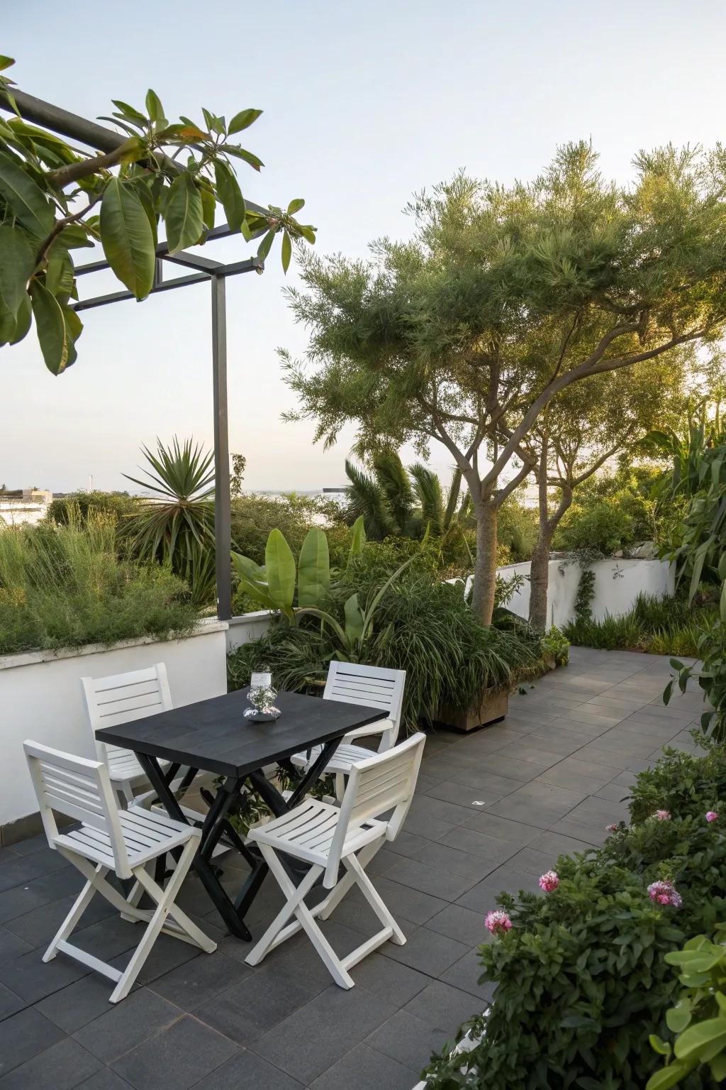 A modern patio with a black table and white chairs, perfect for a stylish gathering.