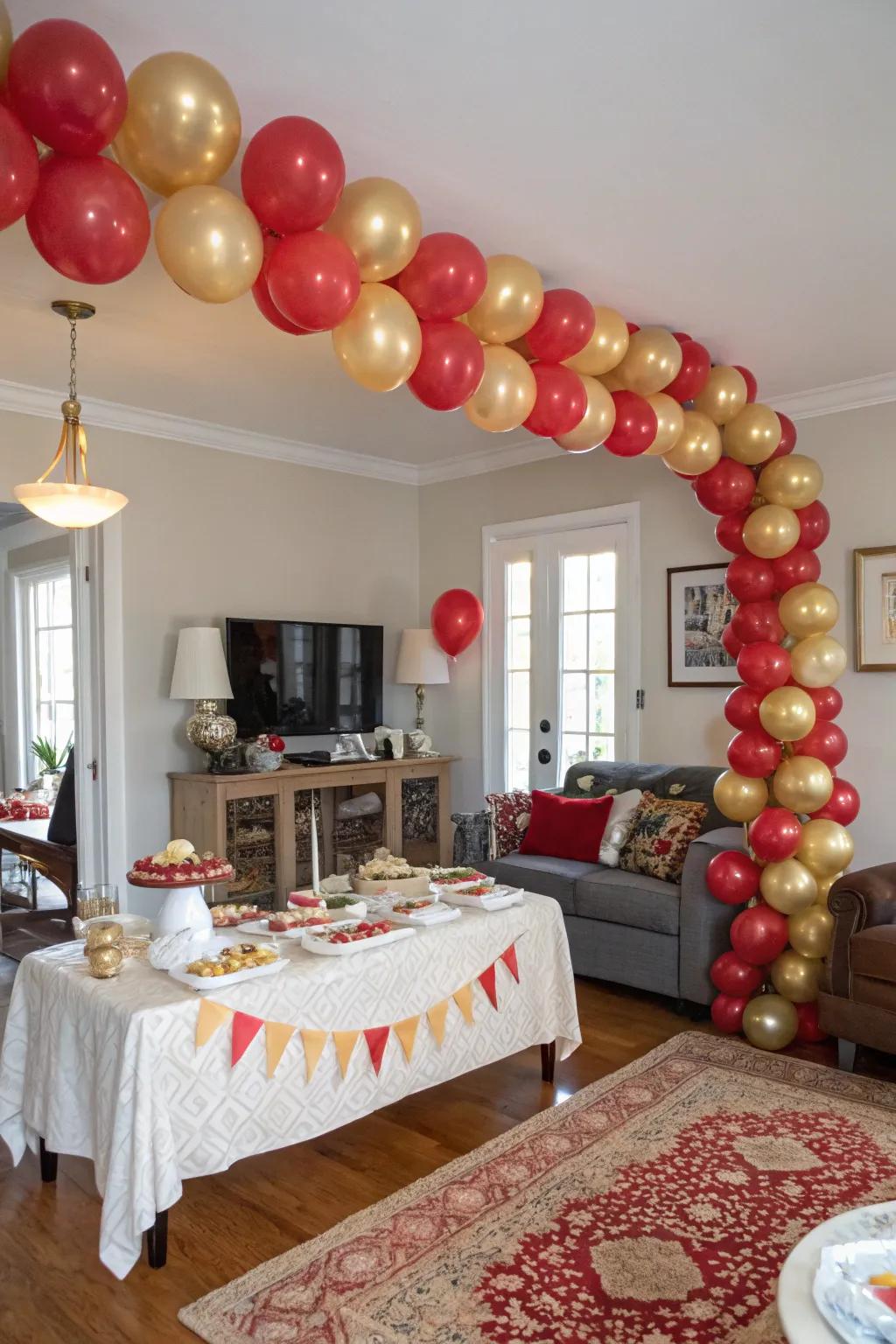 A stunning red and gold balloon garland creates a festive entrance.