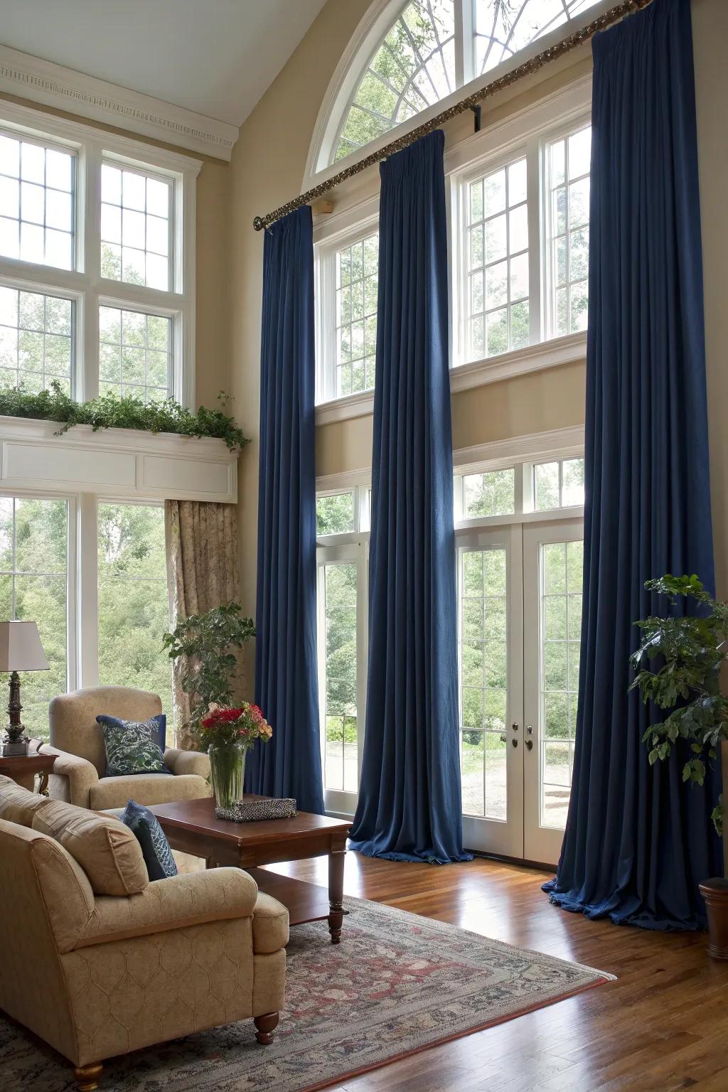 Elegant floor-to-ceiling drapes add height and drama to this glam living room.