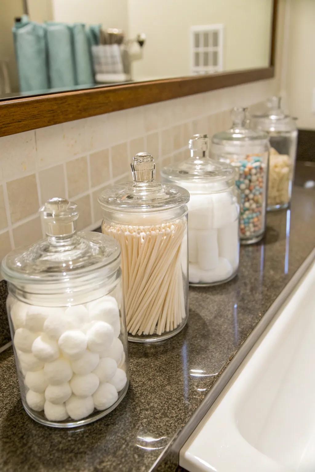 Glass jars provide an elegant way to store small bathroom essentials.