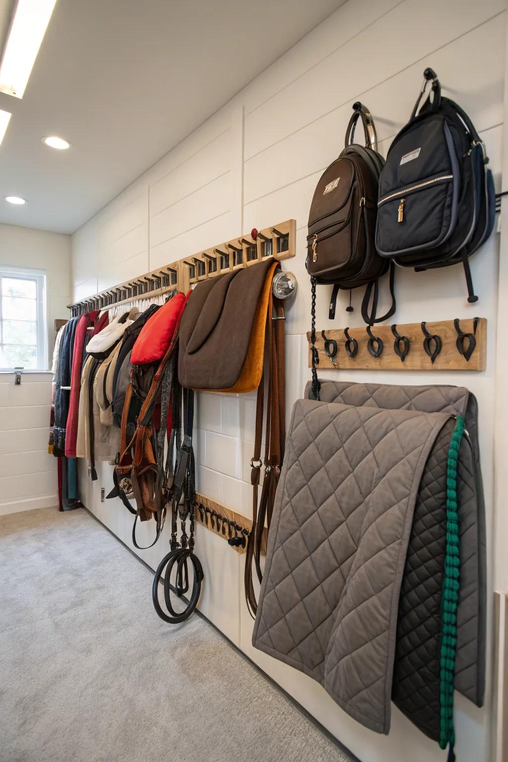 Wall-mounted blanket holders in a tack room for efficient storage.