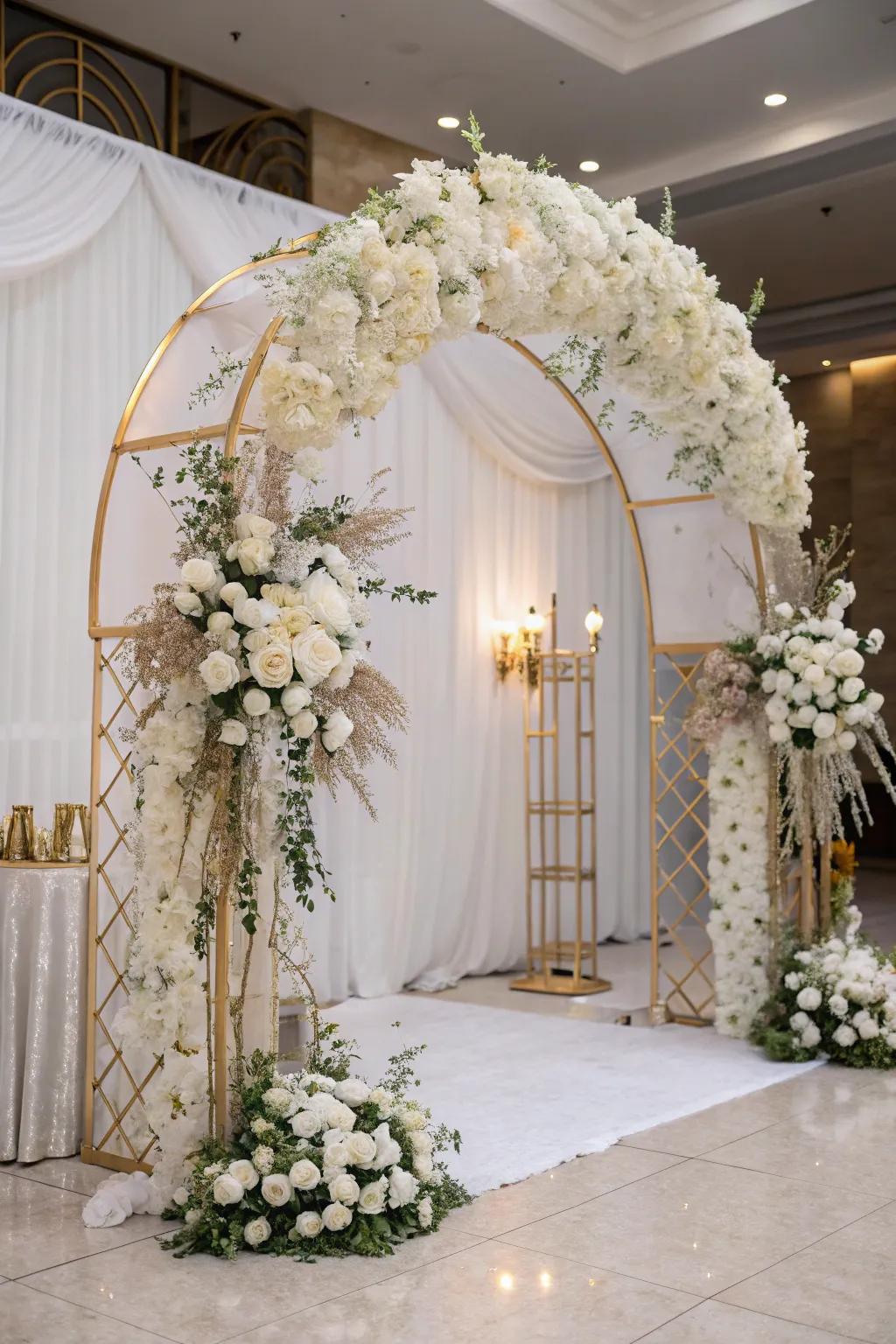 Grand entrance with a floral arch in white and gold.