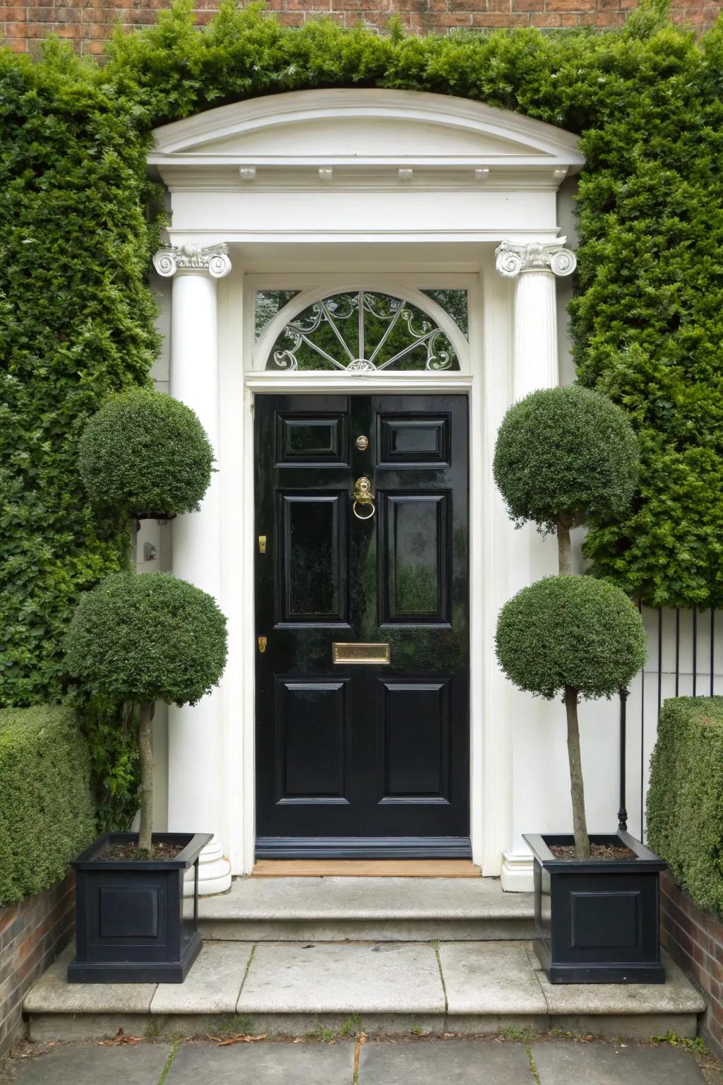 Topiary sculptures add sophistication and a touch of whimsy to a black door.