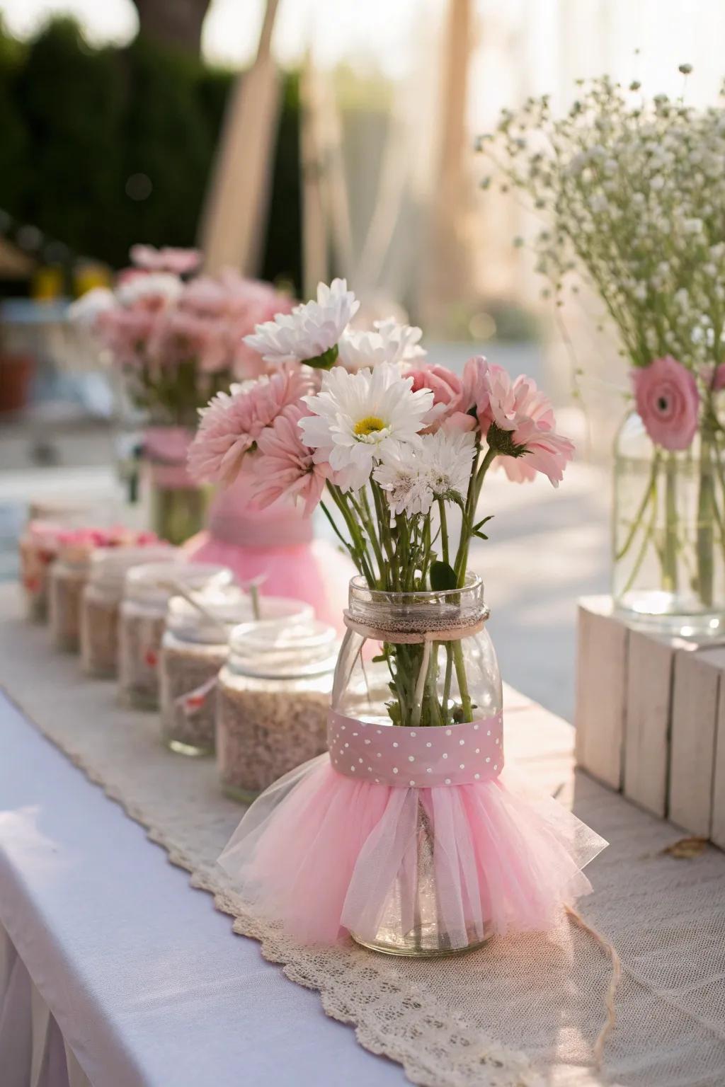 Whimsical centerpieces with mini tutus and soft florals.