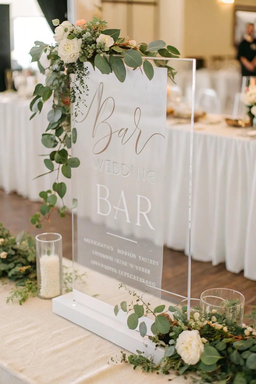 A sophisticated acrylic bar sign with modern typography and greenery.