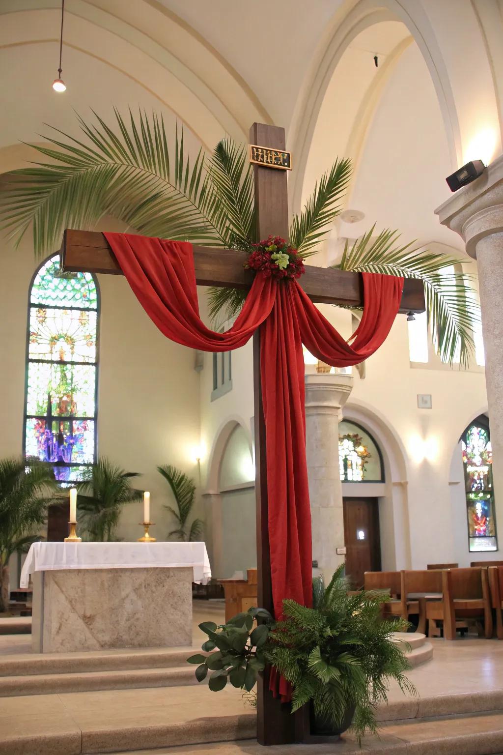 A cross adorned with red fabric and palms, symbolizing Palm Sunday.