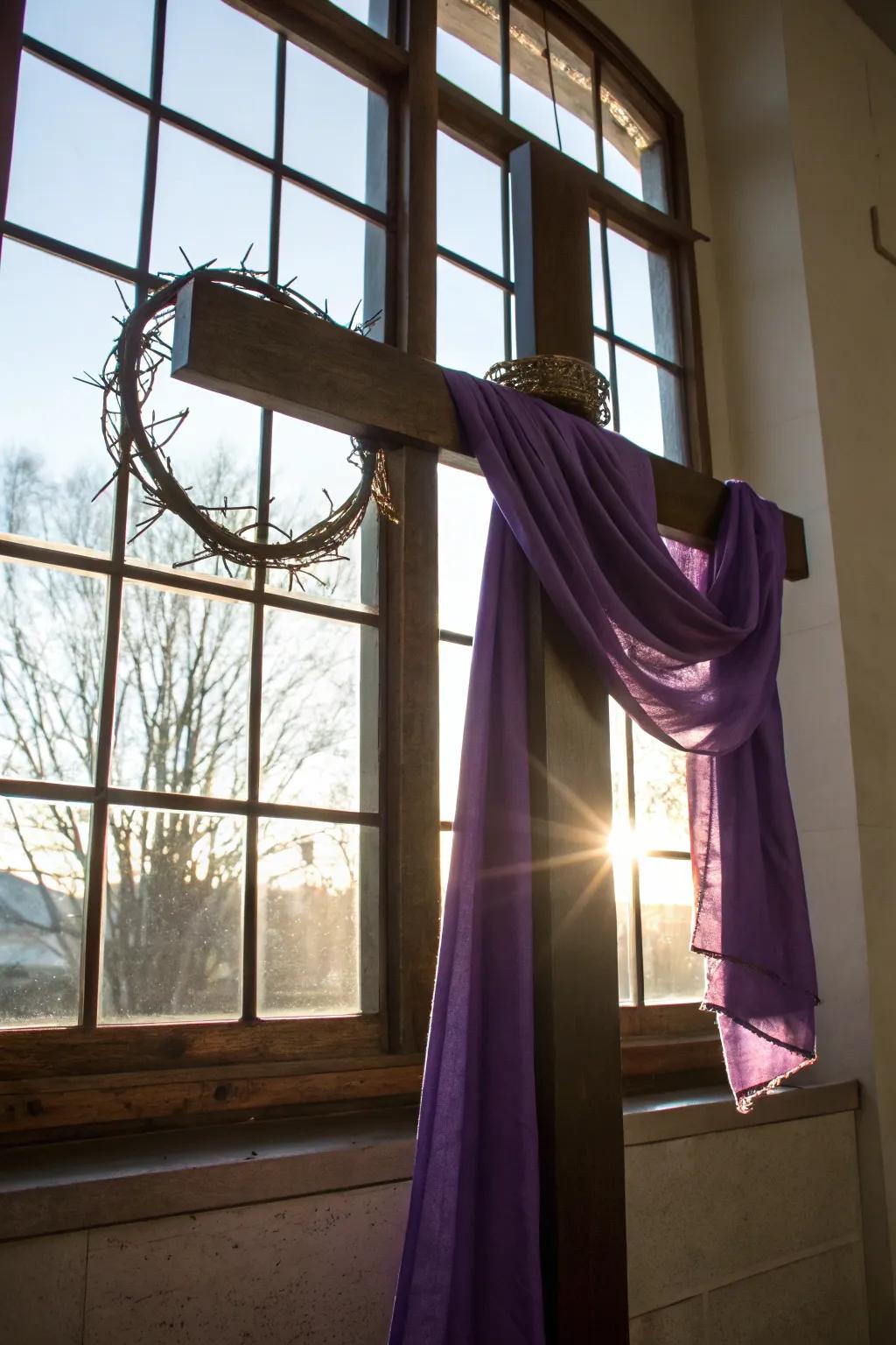 Cross with a crown of thorns and purple cloth