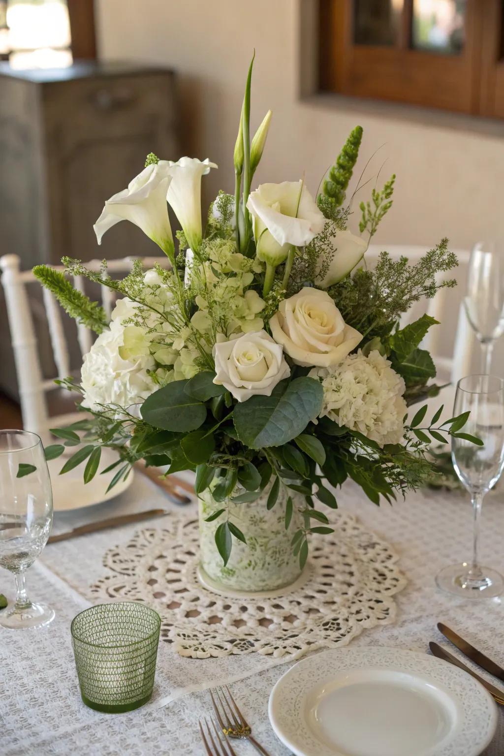 A timeless centerpiece featuring white flowers and lush greenery.