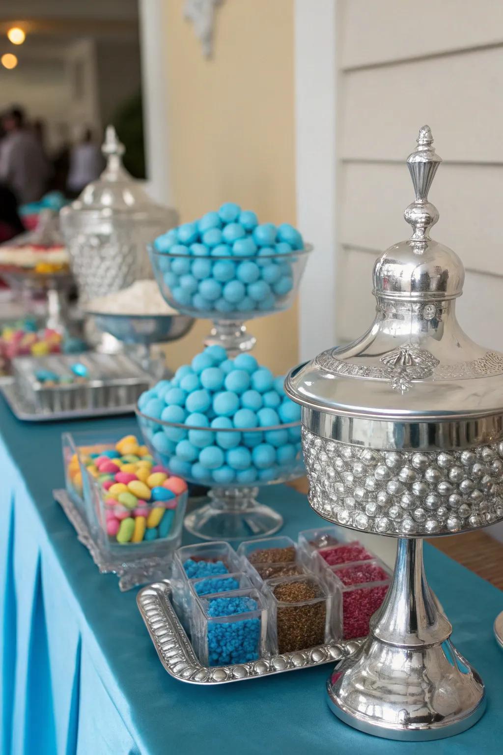 Sophisticated silver accents that elevate the blue candy table.