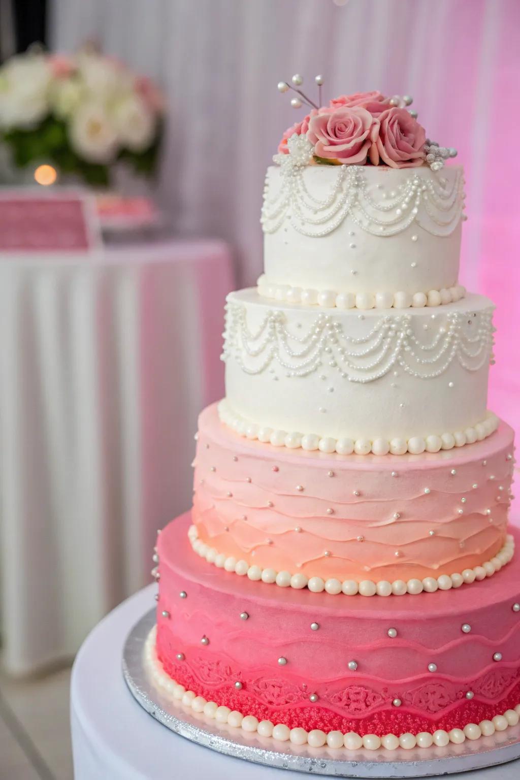 An ombre wedding cake transitioning from white to vibrant pink.