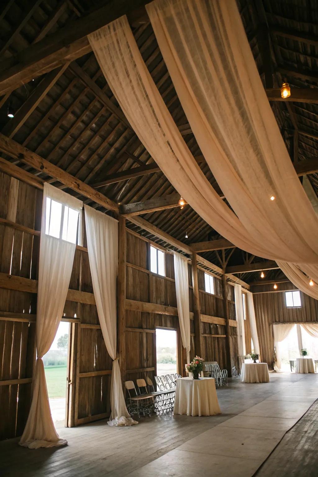 Hanging drapes transform barn spaces with elegance.