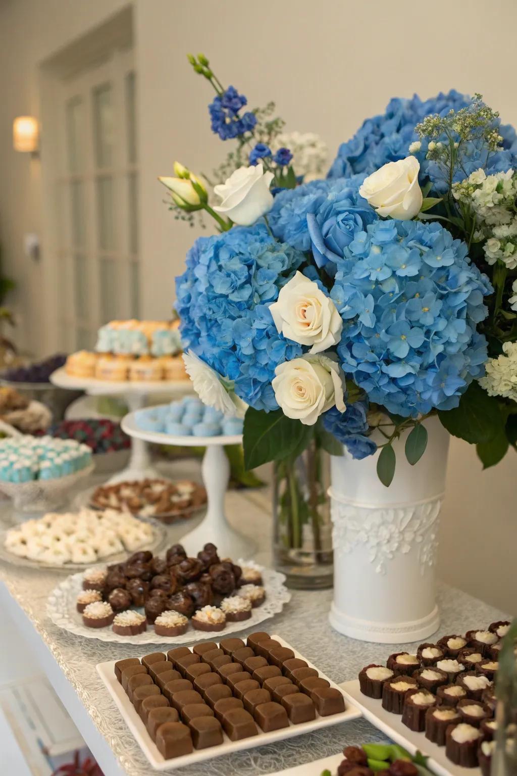 Blue floral arrangements adding a fresh, natural touch to the candy table.